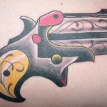 Pistol tattoo by Josh Ford