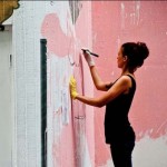 Portrait of Lisa King creating a street artwork
