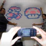 Creatives posing with their Post-it creation of Mario Bros