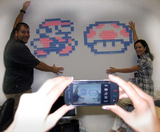 Creatives posing with their Post-it creation of Mario Bros